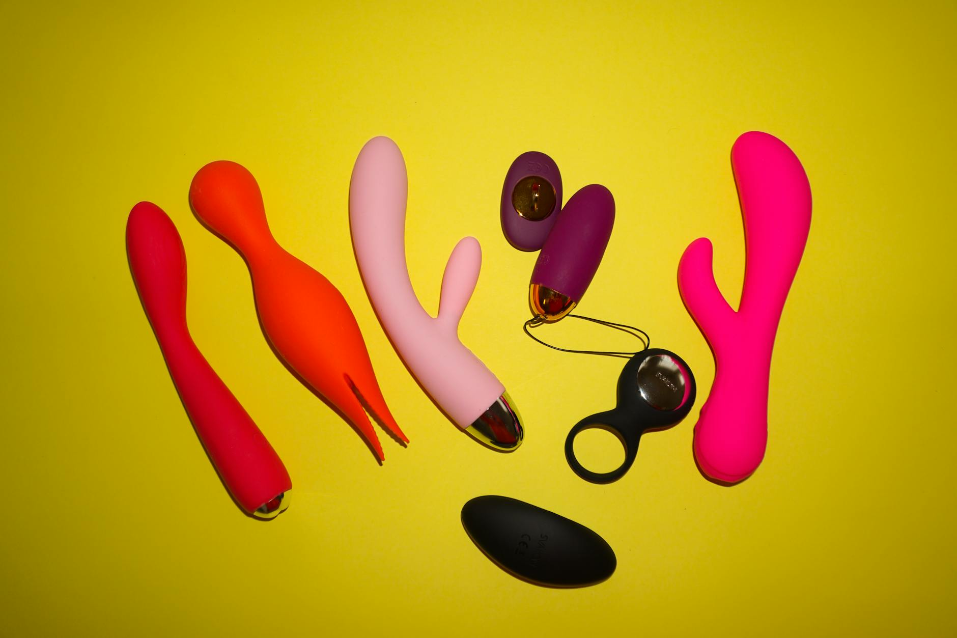A hand holding a basket of colorful vibrators with fresh flowers
