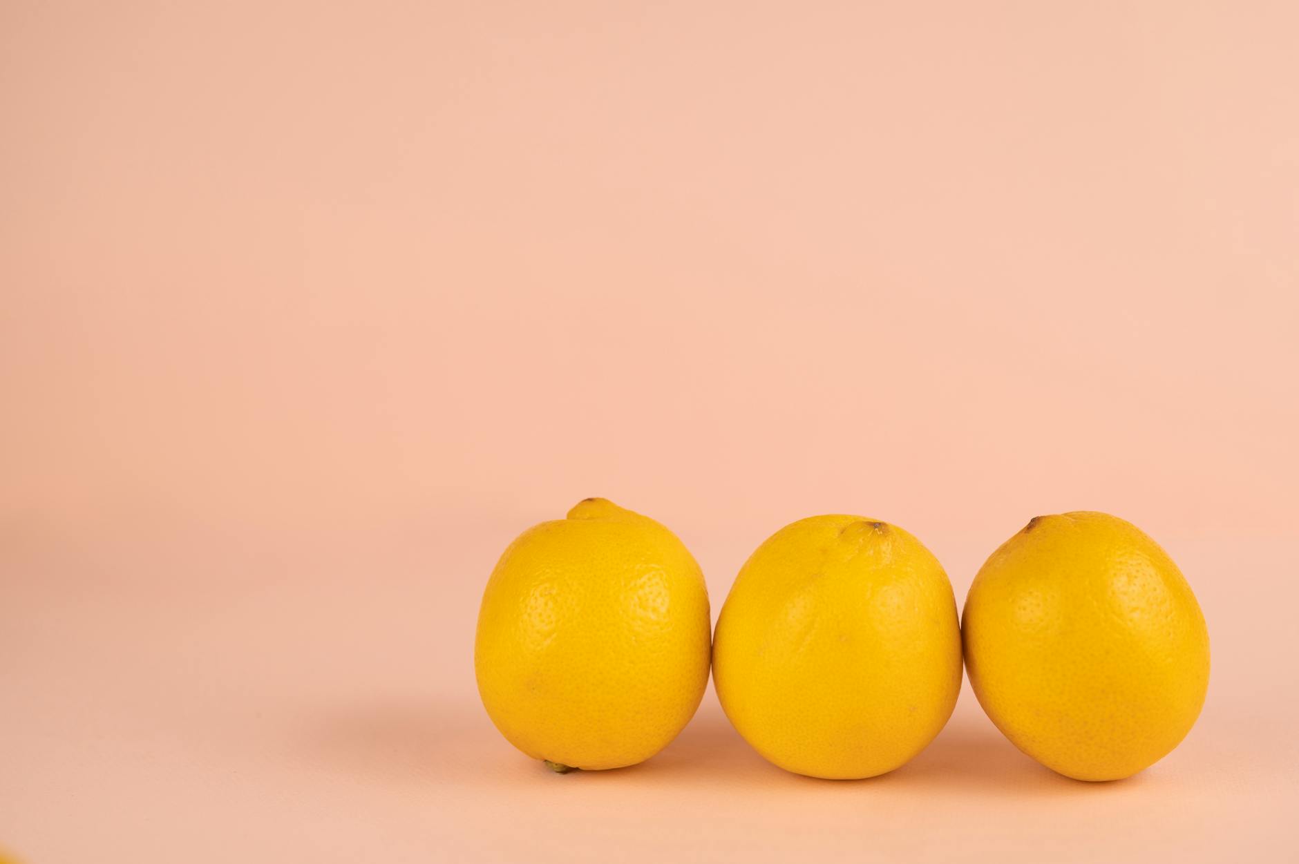 Bright ripe lemons arranged on a pastel background, symbolizing freshness and renewed sensation
